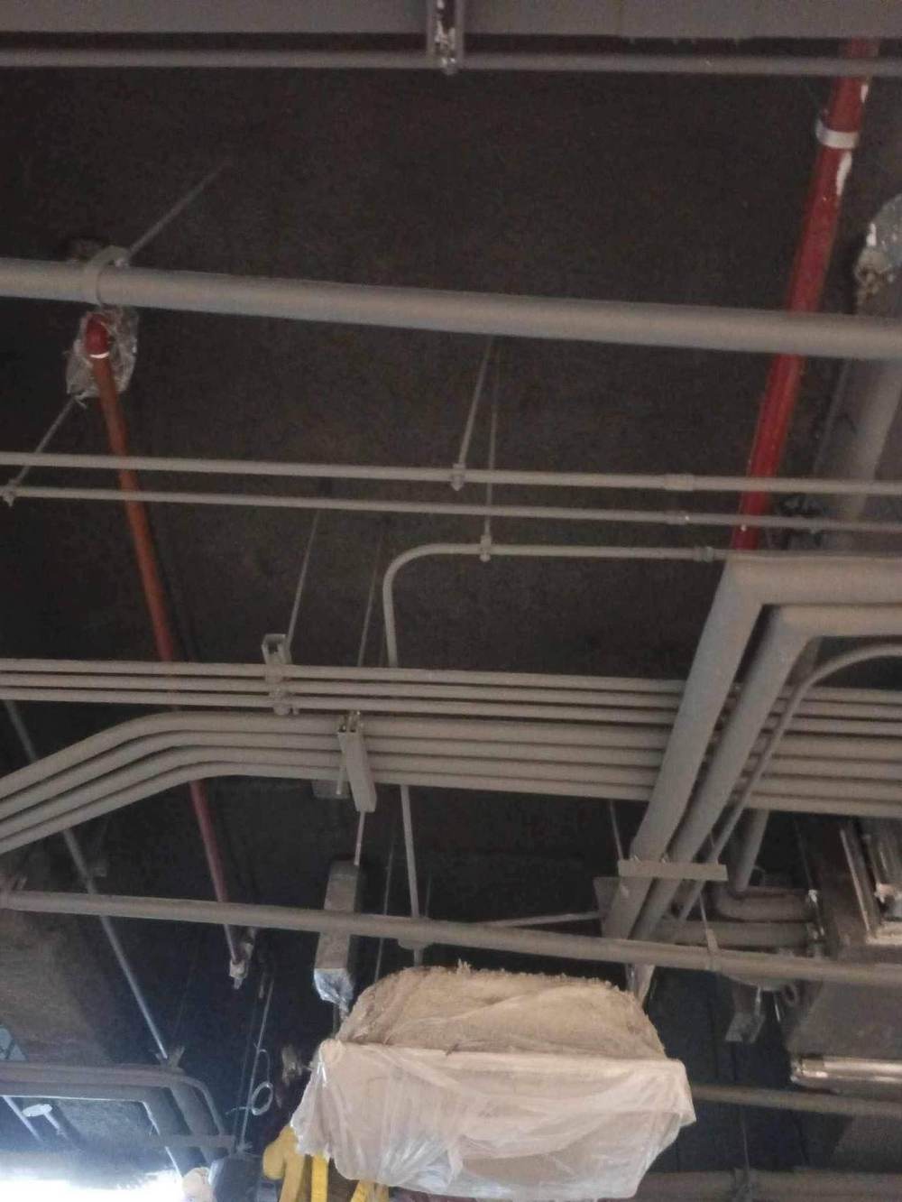 Charcoal-finished NoiseSHIELD on an exposed office soffit